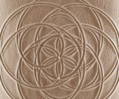 an image of fine powdered sand displaying the image of a sacred fine powder sand mandala