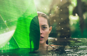 half women face hidden by green leaf